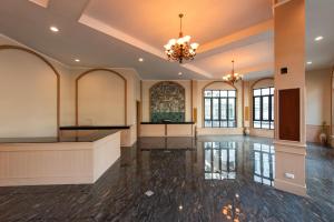 a large room with a dance floor and a chandelier at Peya Rama-7 Hotel in Bang O