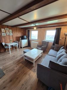 a living room with a couch and a table at Malovaný sklípek in Hlohovec