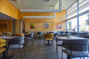 a dining room with tables and chairs in a restaurant at Hotel Creina in Kranj