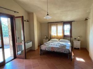 a bedroom with a bed in a room with windows at B&B Papanonno - Relax vicino Palinuro in Centola +15 photos