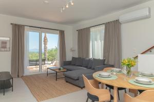 a living room with a couch and a table at Thea Luxury Villa in Kos