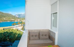 a chair sitting on a balcony with a view at Apartment Matko in Ploče