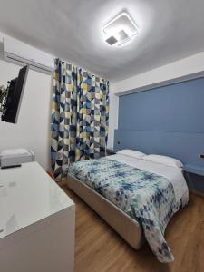 a small bedroom with a bed and a window at Il Giramondo in Aversa