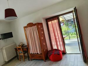 a room with a door and a chair and a table at Chez Bonjour in Villar Pellice