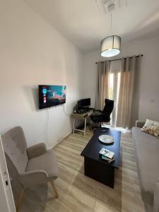 a living room with a couch and a table at METHONI LUXURY House in Methoni