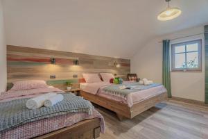 a bedroom with two beds and a window at Lukec Estate in Kostel