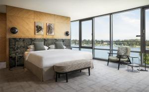 a bedroom with a large bed and a large window at Hyatt Regency Mainz in Mainz +80 photos