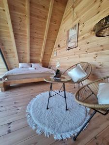 a bedroom with a bed and a table and chairs at SkyFrame cottage with pool in Plav +39 photos
