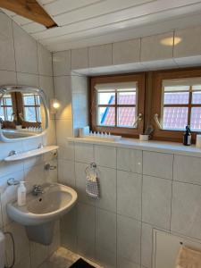 a bathroom with a sink and a mirror at Guest House Naglis in Neringa +41 photos