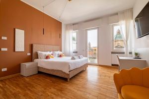 a bedroom with a bed and a large window at Urbanicooh Cavour Rooms&Suite in Bologna