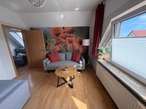 a living room with a couch and a table and a window at Ferienhaus Schmetterling in Nebra