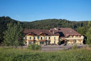 a large house on the side of a road at Logis De La Grande Cascade in Le Tholy