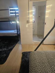 a bedroom with a bunk bed and a mirror at 1krom str bellville boston in Bellville