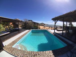 a swimming pool with a view of the ocean at Les Paillottes de Babaomby Hotel in Diego Suarez
