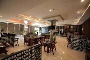 a restaurant with tables and chairs in a room at Days Hotel Jaipur Tonk Road By Wyndham in Jaipur