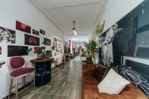 a living room with a couch and some plants at Party Hostel Zzz in Ljubljana