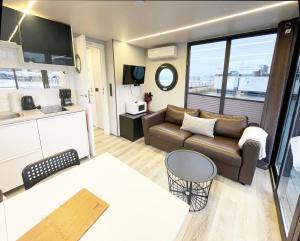 a living room with a couch and a table at Fjord Lyckholm in Schleswig