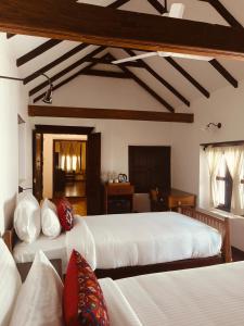 a bedroom with two beds and a couch in it at Ezekiel House Residence in Cochin +184 photos