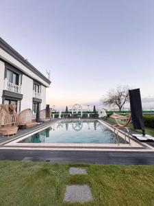 a swimming pool in the yard of a house at Apera Garden in Sancaklı