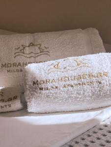 a pile of towels sitting on top of a bed at Mora Houses in Mandrakia