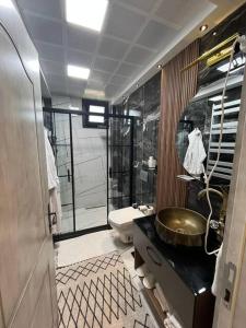 a bathroom with a sink and a shower and a toilet at Apera Garden in Sancaklı