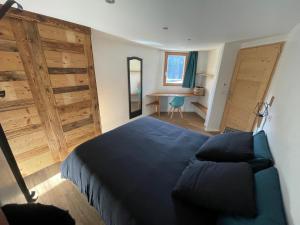 a bedroom with a bed and a chair and a desk at Le balcon du Chemin des Vignes ! in Bozel +5 photos
