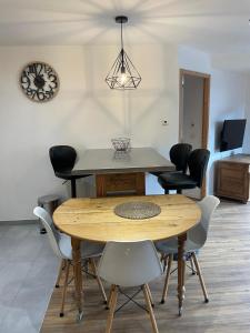 a dining room with a wooden table and chairs at Le balcon du Chemin des Vignes ! in Bozel