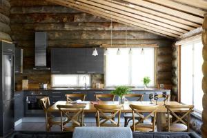 a kitchen with a table and chairs in a room at Hawkhill Resort in Tervalampi