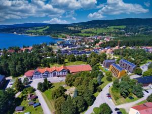 an aerial view of a small town next to a lake at Club Canada Lipno De Luxe in Lipno nad Vltavou