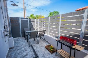 a balcony with a table and chairs and a fence at Mediterranean Studio Halkidiki in Nea Kallikrateia