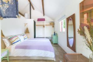 a bedroom with a bed and a mirror at Cozy Countryside Studio in Aldeia do Cano