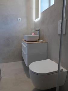 a white bathroom with a sink and a toilet at Villa BORIĆ DARKO in Podgora +31 photos