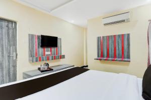 a hotel room with a bed and a television at Amba palace in Prayagraj +22 photos
