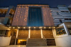 a building with stairs and lights in front of it at Amba palace in Prayagraj