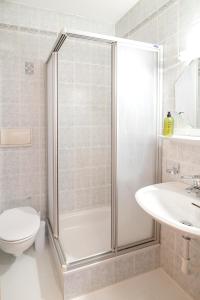 a bathroom with a shower and a toilet and a sink at Rieplhof - Relaxing farm stay with breakfast and mountain view in Vipiteno