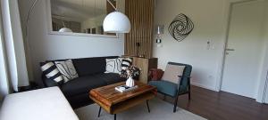 a living room with a couch and a table at Rivera House Mrežnica in Generalski Stol