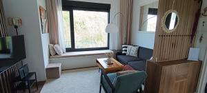 a living room with a couch and a window at Rivera House Mrežnica in Generalski Stol