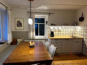 a kitchen with a wooden table with candles on it at K Zastavce 557 in Kovářská +39 photos