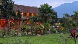 a house with a garden in front of it at The MD Ba Vi Retreat in Ba Vì