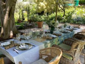 a table with plates and wine glasses on it at Classic Home in Franschhoek in Franschhoek