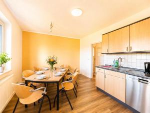 a kitchen with a table and chairs in a room at Gemütlich Wohnen in Kahla bei Jena in Kahla