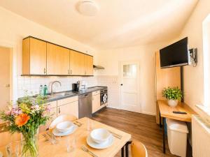 a kitchen with a table and a sink and a kitchen with a tablektop at Gemütlich Wohnen in Kahla bei Jena in Kahla