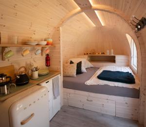 a bed in a tiny house with an archway at Camping Neckargemünd bei Heidelberg in Neckargemünd