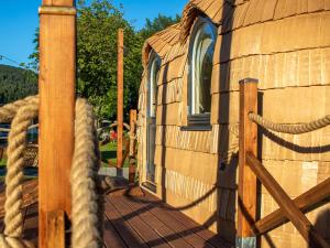 a wooden house with a rope on a deck at Camping Neckargemünd bei Heidelberg in Neckargemünd