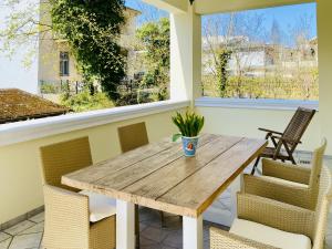 a wooden table and chairs on a patio at Villa Caprivi 1 in Heringsdorf