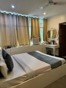 a bedroom with a large bed with a window at Hotel Chandigarh Elite in Chandīgarh