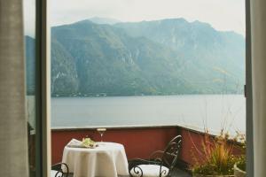 a table and chairs with a view of a lake at Belvedere Bellagio in Bellagio