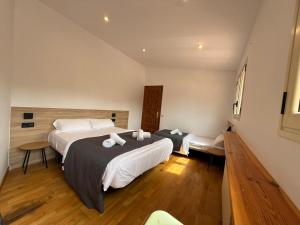 a hotel room with two beds and a table at Cubez Viladrau by Dynamic Hotels in Viladrau