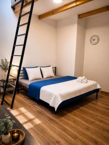a bedroom with a bunk bed and a ladder at Centrum Rosenbaum in Beroun