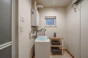 a small bathroom with a toilet and a sink at Sapporo Nakajima Parkhouse in Sapporo +71 photos